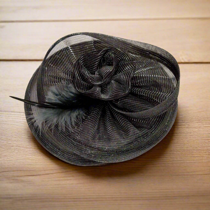 Twisted metallic grey fascinator hat with feather